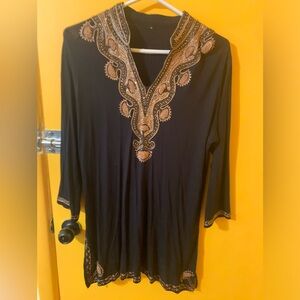 Embroidered long light black shirt with long sleeves.